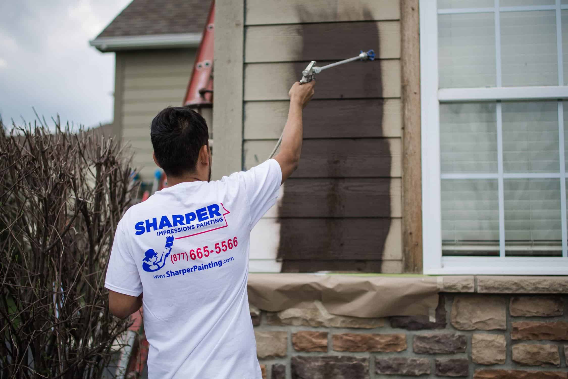 5N1A2054-14 painter working on the exterior of the house