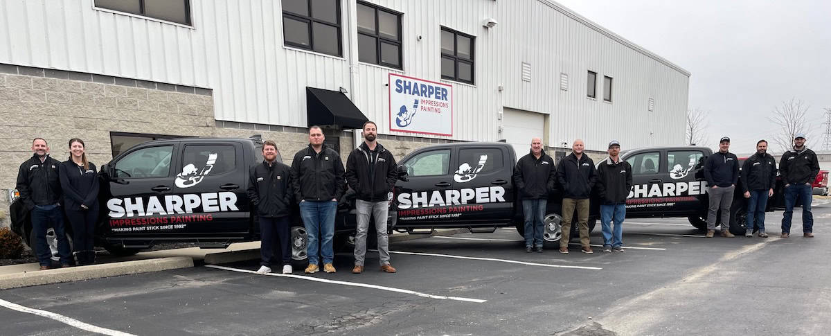 Sharper's team photo with company truck behind