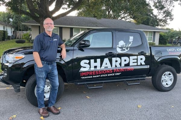 Mark photo with the company truck behind