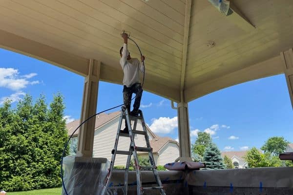 Oscar on a ladder painting ceiling