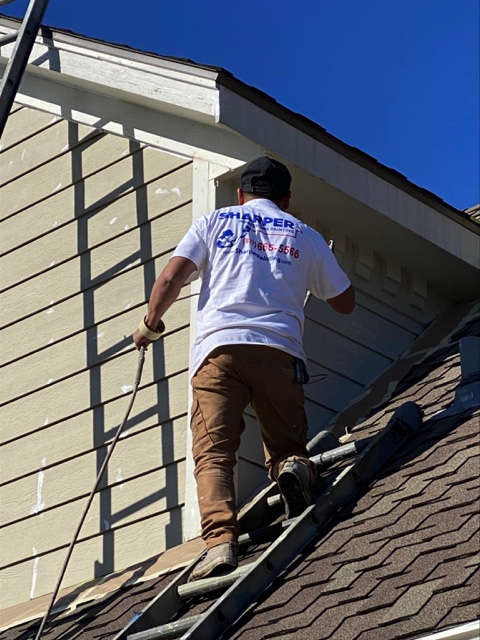 a painter painting the roof