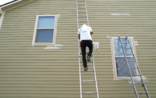 Painter painting the exterior of a house